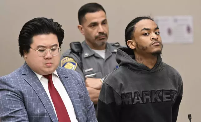 Suspect Tajuan Washington, with public defender Justin Chan, during his arraignment Wednesday May 28, 2025, in Waterbury Superior Court and has been charged with assault and weapons crimes in a shooting at the Brass Mill Center on Tuesday afternoon, May 27, in Waterbury, Conn. (Jim Shannon/Hearst Connecticut Media via AP)