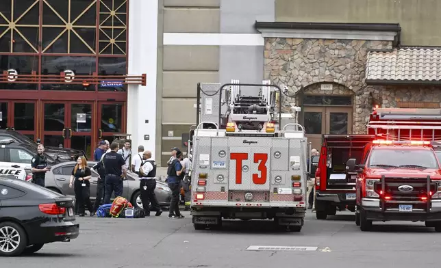 Waterbury police and emergency first responders are at Brass Mill Center, where several people were shot on Tuesday afternoon, May 27, 2025, in Waterbury, Conn. (Jim Shannon/Hearst Connecticut Media via AP)