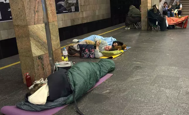 People take shelter at Kontraktova Ploshcha subway station during a Russian drone and missile attack in Kyiv, Ukraine, Saturday, May 24, 2025. (AP Photo/Illia Novikov)