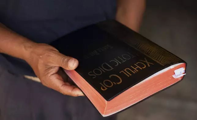 Deacon Juan Pérez Gómez holds a Bible translated into Tsotsil, a Mayan language, in the Simojovel municipality, Mexico, Saturday, April 26, 2025. (AP Photo/Isabel Mateos)