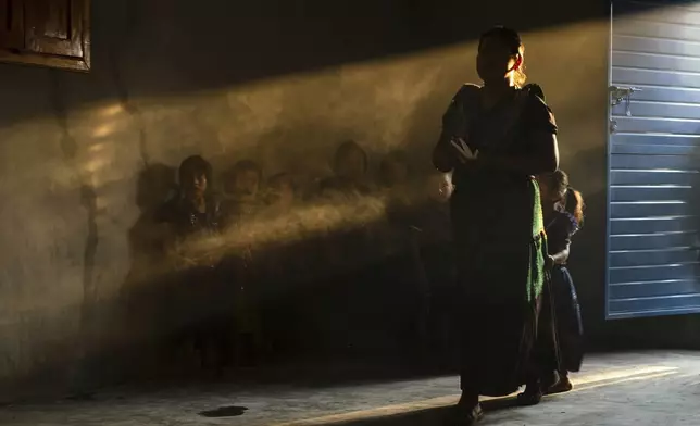 Congregants attend an Indigenous blessing ceremony for Communion wafers that will be taken to a priest to be consecrated before they can be given out, in the Simojovel municipality, Mexico, Saturday, April 26, 2025. (AP Photo/Isabel Mateos)