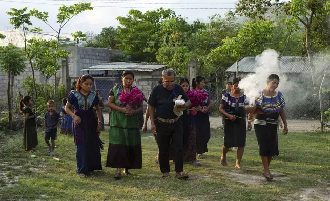 Deacon Juan Pérez Gómez, center, takes part in a blessing ceremony after picking up Communion wafers that need to be taken to a priest to be consecrated before he can give them out in his next day service, in the Simojovel municipality, Mexico, Saturday, April 26, 2025. (AP Photo/Isabel Mateos)