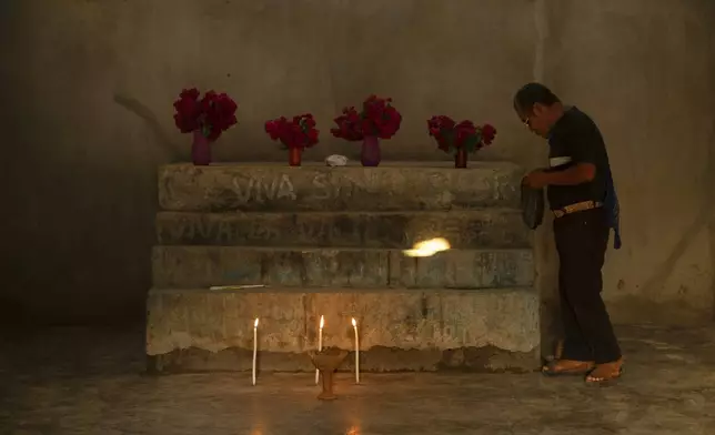 Deacon Juan Pérez Gómez prepares the altar for a Sunday Mass, in the Simojovel municipality, Mexico, Saturday, April 26, 2025. (AP Photo/Isabel Mateos)
