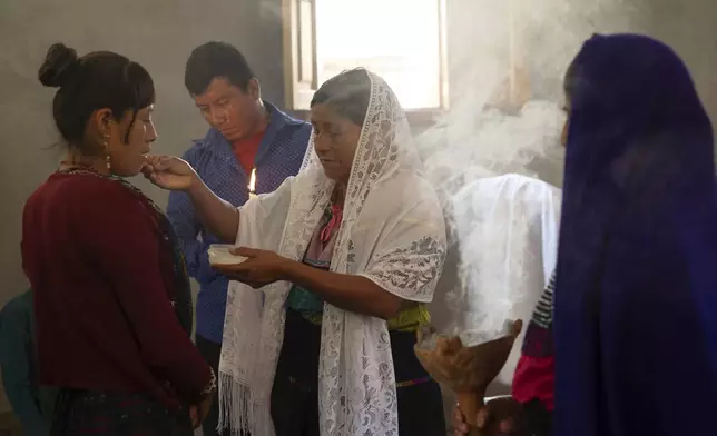 FILE - Crecencia López, wife of Deacon Juan Pérez Gómez, offers Communion wafers during a Mass honoring the late Pope Francis, in the Simojovel municipality, Mexico, April 27, 2025. (AP Photo/Isabel Mateos, File)