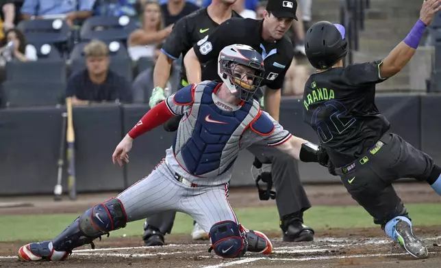 Minnesota Twins catcher Ryan Jeffers tags out Tampa Bay Rays' Jonathan Aranda (62) as Aranda trys to steal home during the second inning of a baseball game Tuesday, May 27, 2025, in Tampa, Fla. (AP Photo/Jason Behnken)