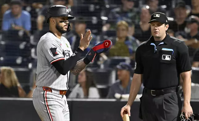 Minnesota Twins' Carlos Correa (4) celebrates after scoring on a Ty France (not pictured) single during the eight inning of a baseball game against the Tampa Bay Rays, Tuesday, May 27, 2025, in Tampa, Fla. (AP Photo/Jason Behnken)