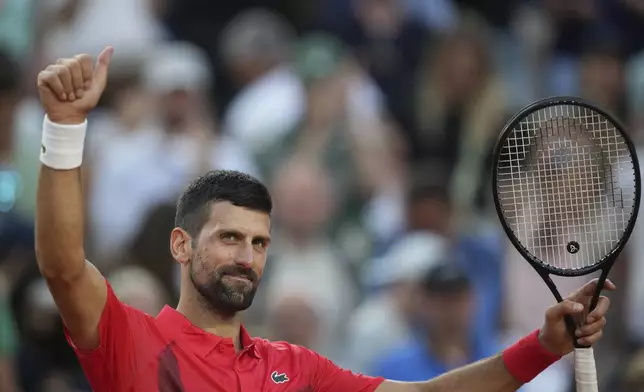 Serbia's Novak Djokovic celebrates beating France's Corentin Moutet after their second round match of the French Tennis Open, at the Roland-Garros stadium, in Paris, Thursday, May 29, 2025. (AP Photo/Christophe Ena)
