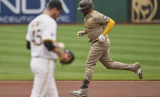 San Diego Padres' Elias Díaz, right, rounds the bases after hitting a solo home run off Pittsburgh Pirates pitcher Andrew Heaney (45) during the second inning of a baseball game in Pittsburgh, Sunday, May 4, 2025. (AP Photo/Gene J. Puskar)