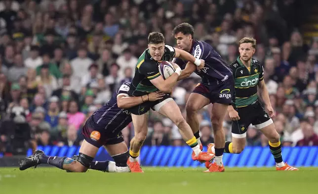 Northampton Saints' Tommy Freeman is tackled during the Investec Champions Cup final between Northampton Saints and Bordeaux-Begles, at the Principality Stadium, Cardiff, Wales, Saturday May 24, 2025. (Adam Davy/PA via AP)
