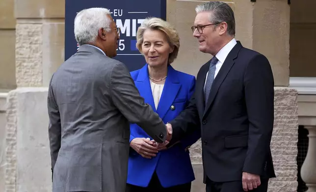 Britain's Prime Minister Keir Starmer, right, welcomes European Commission President Ursula von der Leyen and European Council President Antonio Costa to attend a United Kingdom and European Union summit at Lancaster House, London, Monday, May 19, 2025. (Carl Court/Pool Photo via AP)