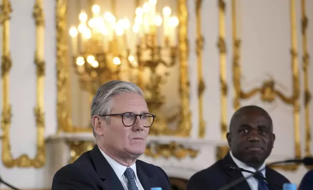Britain's Prime Minister Keir Starmer and Foreign Secretary David Lammy listen during a meeting between the U.K. and the European Union to discuss closer ties in their first official summit since Brexit, in London, Monday, May 19, 2025.(AP Photo/Kin Cheung, Pool)