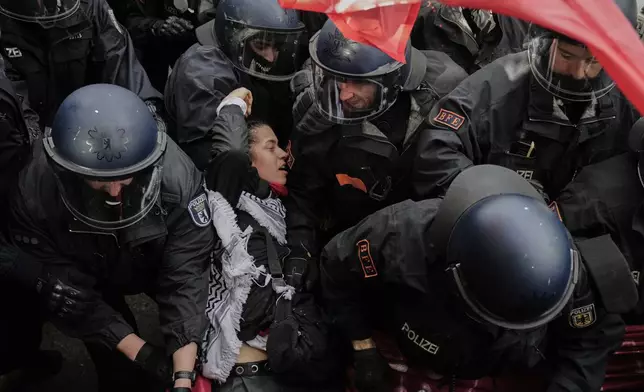 Police officers clash with protesters during a demonstration to commemorate the Nakba Day in Berlin, Germany, Thursday, May 15, 2025. (AP Photo/Ebrahim Noroozi)