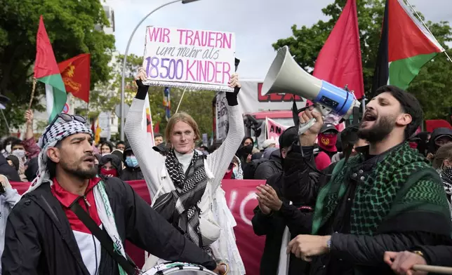 People attend a pro-Palestinians demonstration to commemorate the Nakba Day in Berlin, Germany, Thursday, May 15, 2025. Slogan reads: 'we mourn the loss of more than 18.500 children'. (AP Photo/Ebrahim Noroozi)