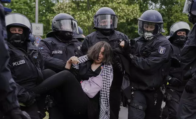 Police officers arrest a pro-Palestinians during a demonstration to commemorate the Nakba Day in Berlin, Germany, Thursday, May 15, 2025. (AP Photo/Ebrahim Noroozi)