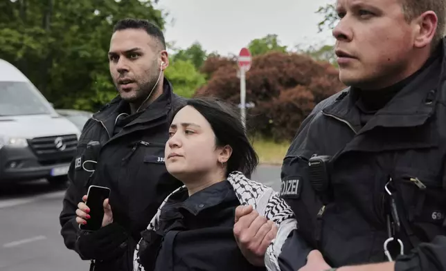 Police officers arrest a pro-Palestinians during a demonstration to commemorate the Nakba Day in Berlin, Germany, Thursday, May 15, 2025. (AP Photo/Ebrahim Noroozi)