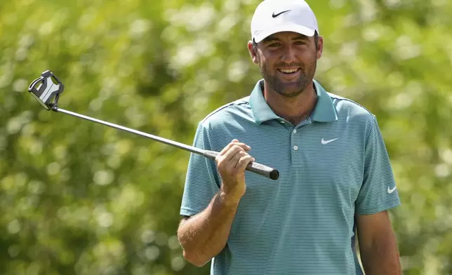 Scottie Scheffler smiles on the seventh hole during the third round of the PGA Championship golf tournament at the Quail Hollow Club, Saturday, May 17, 2025, in Charlotte, N.C. (AP Photo/Matt York)