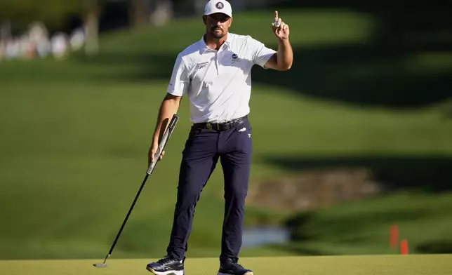 Bryson DeChambeau waves on the 18th hole during the third round of the PGA Championship golf tournament at the Quail Hollow Club, Saturday, May 17, 2025, in Charlotte, N.C. (AP Photo/Matt York)