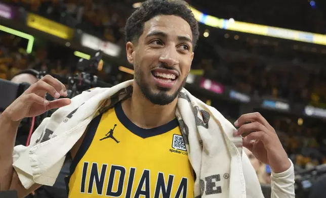 Indiana Pacers guard Tyrese Haliburton (0) celebrates the team's win after Game 4 of the Eastern Conference finals of the NBA basketball playoffs against the New York Knicks in Indianapolis, Tuesday, May 27, 2025. (AP Photo/Michael Conroy)