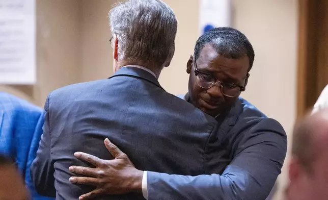 Former Memphis Police Department officer Justin Smith Jr., right, becomes emotional as he hugs Michael Stengel, left, the defense attorney for fellow former officer Demetrius Haley, after Smith and the other two former officers were found not guilty on all charges by the jury on the ninth day of the trial for the death of Tyre Nichols in Memphis, Tenn., Wednesday, May 7, 2025. (Chris Day/Commercial Appeal/USA Today Network via AP, Pool)
