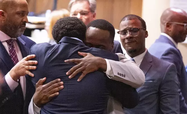 Former Memphis Police Department officers Demetrius Haley, left, and Tadarrius Bean, center, hug as Justin Smith Jr., right, becomes emotional behind them after they were acquitted of state charges, including second-degree murder, in the fatal beating of Tyre Nichols after he ran away from a traffic stop. Wednesday, May 7, 2025, in Memphis, Tenn. (Chris Day/Commercial Appeal/USA Today Network via AP, Pool)
