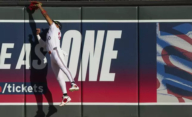 Minnesota Twins right fielder Willi Castro (50) makes a leaping catch at the wall for an out on the San Francisco Giants during the first inning of a baseball game Saturday, May 10, 2025, in Minneapolis. (AP Photo/Ellen Schmidt)