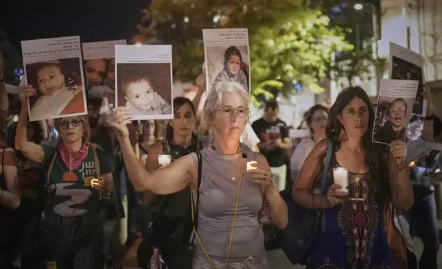 Protesters hold pictures of Palestinian children killed during Israel's military operation in the Gaza Strip in a protest demanding the end of the war, in Tel Aviv, Israel, Saturday, May 17, 2025. (AP Photo/Maya Alleruzzo)