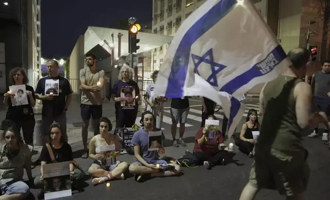 Protesters hold pictures of Palestinian children killed during Israel's military operation in the Gaza Strip in a protest demanding the end of the war, in Tel Aviv, Israel, Saturday, May 17, 2025. (AP Photo/Maya Alleruzzo)