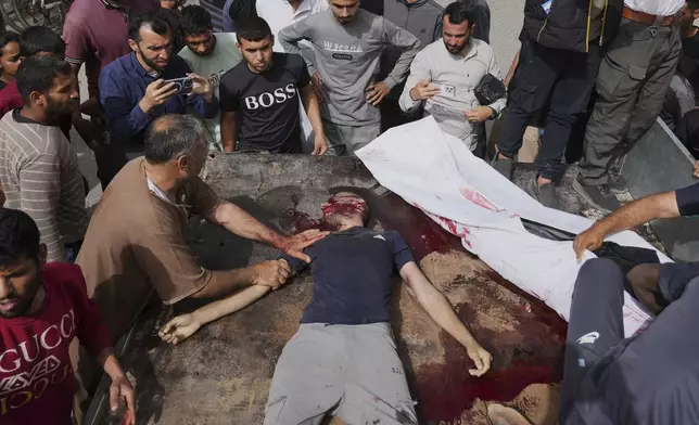 EDS NOTE: GRAPHIC CONTENT - Palestinians killed in an Israeli airstrike on central Gaza Strip are brought to Al-Aqsa Hospital in Deir al-Balah, on Saturday, May 17, 2025. (AP Photo/Abdel Kareem Hana)