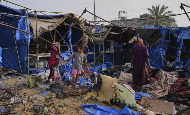 Palestinians inspect the damage caused by an Israeli airstrike that struck tents at Al-Aqsa Hospital in Deir al-Balah, central Gaza Strip, Saturday, May 17, 2025. (AP Photo/Abdel Kareem Hana)