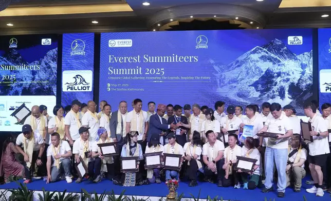 Climbers who successfully summited Mount Everest pose for a picture during the Everest Summiteers Summit in Kathmandu, Nepal, on Tuesday, May 27, 2025. (AP Photo/Niranjan Shrestha)