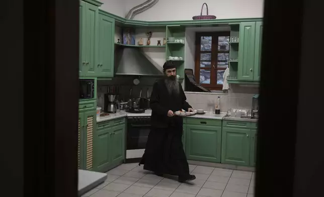 Father Serafeim, a Lebanese-Syrian, prepares coffee in the kitchen of Simonopetra, or the Simonos Petra Monastery, home of the all-male autonomous community Agion Oros, or Holy Mountain, on the peninsula of Mount Athos in northern Greece, Monday, April 14, 2025. (AP Photo/Thanassis Stavrakis)