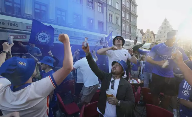 Chelsea fans light up flares ahead of the Europa Conference League final soccer match between Real Betis and Chelsea in Wroclaw, Poland, Tuesday, May 27, 2025. (AP Photo/ Czarek Sokolowski)