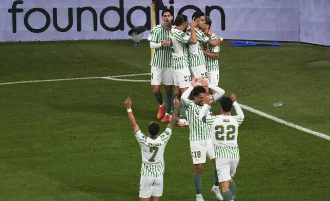 Betis' Abde Ezzalzouli, right, celebrates with his teammates after scoring his side's opening goal during the Europa Conference League final soccer match between Real Betis and Chelsea in Wroclaw, Poland, Wednesday, May 28, 2025. (AP Photo/Darko Vojinovic)