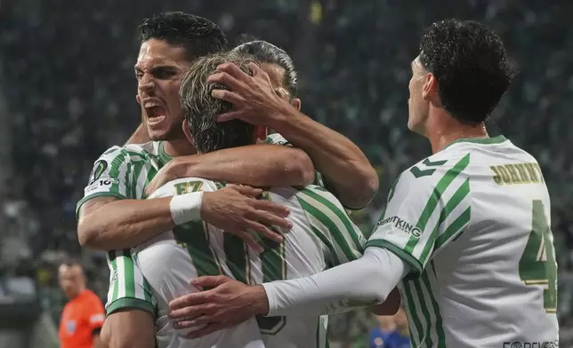 Real Betis players celebrate after Betis' Abde Ezzalzouli, centre, scored his side's opening goal during the Europa Conference League final soccer match between Real Betis and Chelsea in Wroclaw, Poland, Wednesday, May 28, 2025. (AP Photo/Czarek Sokolowski)