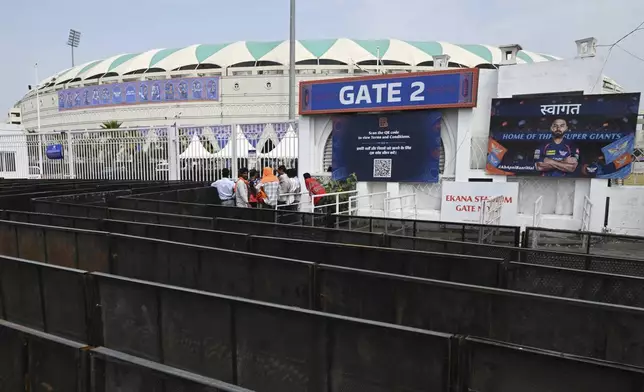 Fans wait outside a closed entrance of Atal Bihari Vajpayee Ekana Cricket Stadium after organizers suspended the Indian Premier League for one week following the escalating military tensions with Pakistan, in Lucknow, India, Friday, May 9, 2025. (AP Photo)