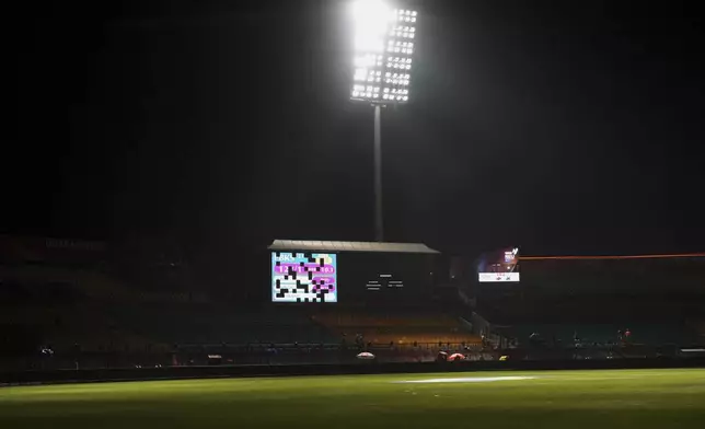 A display board is partially lit after the authorities asked to evacuate the stadium during the Indian Premier League cricket match between Punjab Kings and Delhi Capitals at Himachal Pradesh Cricket Association Stadium in Dharamshala, India, Thursday, May 8, 2025. (AP Photo/Ashwini Bhatia)