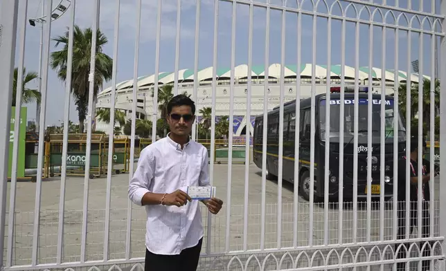 A fan displays his ticket outside a closed entrance of Atal Bihari Vajpayee Ekana Cricket Stadium after organizers suspended the Indian Premier League for one week following the escalating military tensions with Pakistan, in Lucknow, India, Friday, May 9, 2025. (AP Photo)