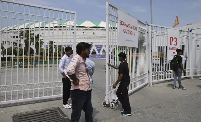 A security guard closes the gate of Atal Bihari Vajpayee Ekana Cricket Stadium after organizers suspended the Indian Premier League for one week following the escalating military tensions with Pakistan, in Lucknow, India, Friday, May 9, 2025. (AP Photo)