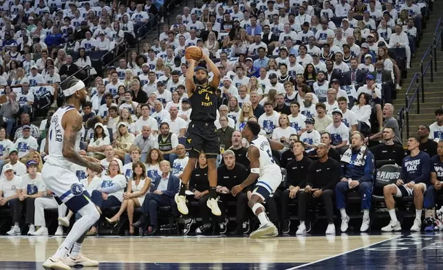 Golden State Warriors guard Moses Moody (4) shoots over Minnesota Timberwolves guard Anthony Edwards (5) during the first half of Game 1 of an NBA basketball second-round playoff series, Tuesday, May 6, 2025, in Minneapolis. (AP Photo/Abbie Parr)