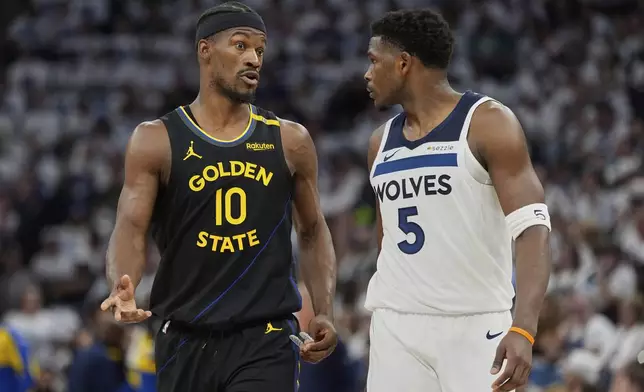 Golden State Warriors forward Jimmy Butler III (10) and Minnesota Timberwolves guard Anthony Edwards (5) walk across the court during the first half of Game 1 of an NBA basketball second-round playoff series, Tuesday, May 6, 2025, in Minneapolis. (AP Photo/Abbie Parr)