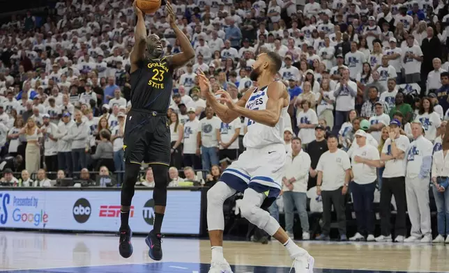 Golden State Warriors forward Draymond Green (23) shoots over Minnesota Timberwolves center Rudy Gobert (27) during the first half of Game 1 of an NBA basketball second-round playoff series, Tuesday, May 6, 2025, in Minneapolis. (AP Photo/Abbie Parr)