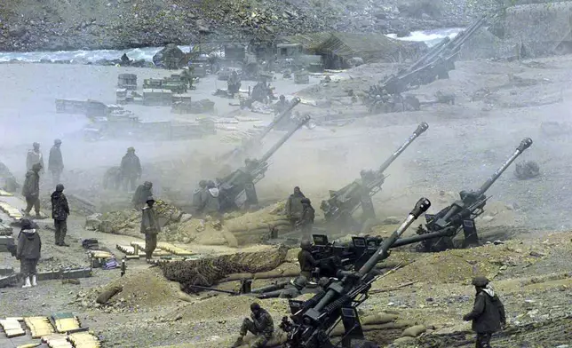 FILE -A battery of Indian army artillery guns fire at the positions of Islamic guerillas in the Dras sector of Kashmir, June 1, 1999. (AP Photo/Saurabh Das, File)