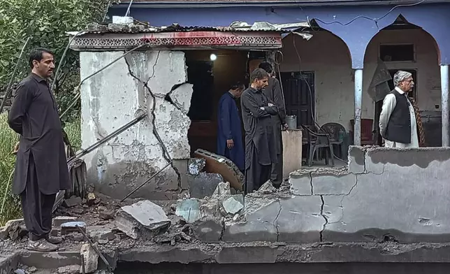 Local residents examine their damaged house following overnight shelling from India, in Haveli Kahuta, a district of Pakistan's administered Kashmir, Friday, May 9, 2025. (AP Photo/Rashid Ahmed)