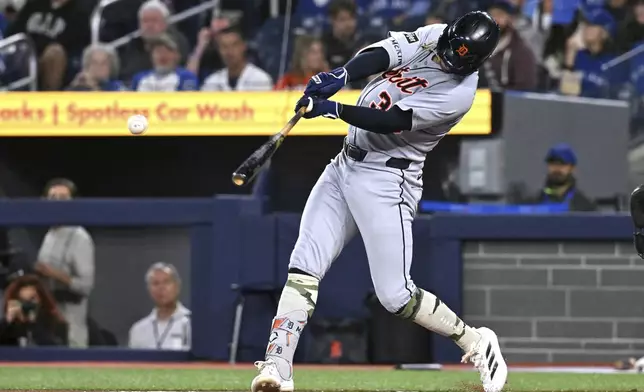 Detroit Tigers' Zach McKinstry hits a single against the Toronto Blue Jays in first-inning baseball game action in Toronto, Sunday, May 18, 2025. (Jon Blacker/The Canadian Press via AP)