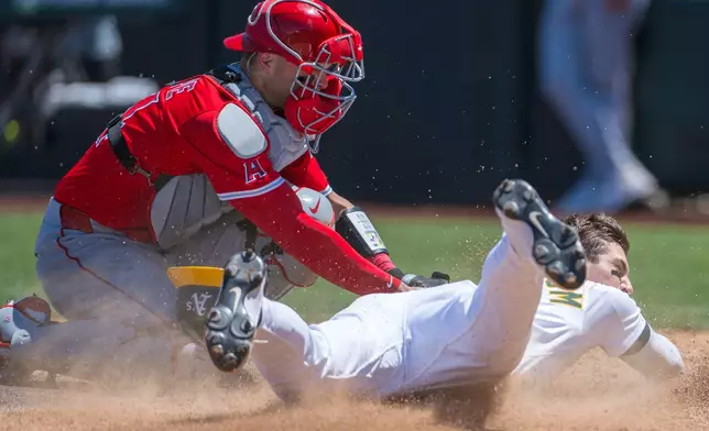 Athletics' Tyler Soderstrom is tagged out at home by Los Angeles Angels catcher Logan O'Hoppe during the fifth inning of a baseball game in West Sacramento, Calif., Thursday, May 22, 2025. (AP Photo/Nic Coury)