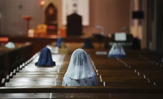 Catholics attend an early morning Mass at the Urakami Cathedral in Nagasaki, southern Japan Saturday, April 26, 2025. (AP Photo/Eugene Hoshiko)