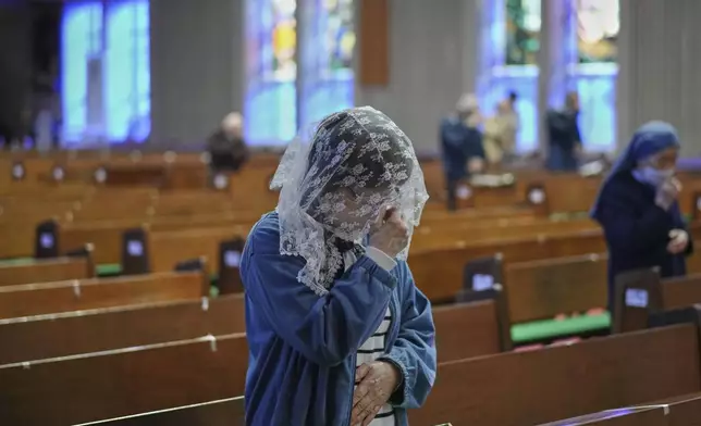 Catholics attend early morning Mass at the Urakami Cathedral in Nagasaki, southern Japan Saturday, April 26, 2025. (AP Photo/Eugene Hoshiko)