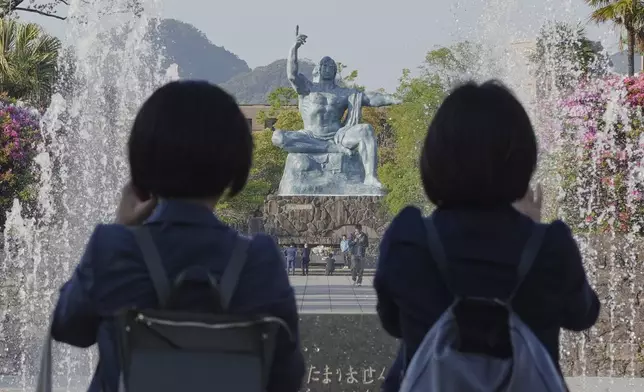 Visitors observe the Statue of Peace at the Peace Park in Nagasaki, southern Japan Friday, April 25, 2025. (AP Photo/Eugene Hoshiko)