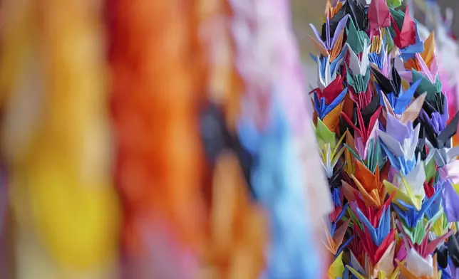 Visitors decorate Peace Park with colorful origami cranes in Nagasaki, southern Japan, Saturday, April 26, 2025. (AP Photo/Eugene Hoshiko)