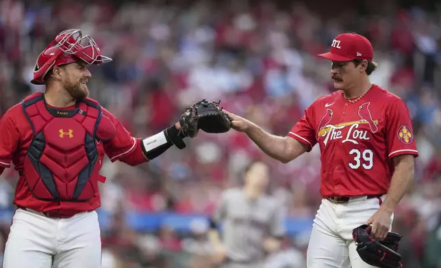 St. Louis Cardinals starting pitcher Miles Mikolas (39) is congratulated by catcher Pedro Pages after working the second inning of a baseball game against the Arizona Diamondbacks Friday, May 23, 2025, in St. Louis. (AP Photo/Jeff Roberson)